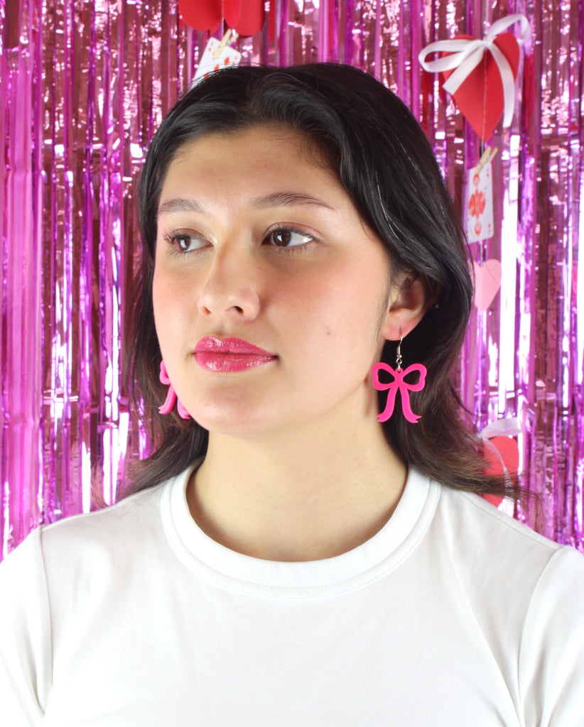 Model wearing Hot Pink Bow Charms on stainless steel earwires 