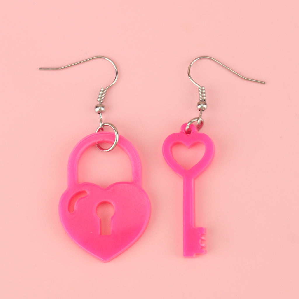 pink acrylic heart padlock charm and a heart-shaped key charm on stainless steel earwires