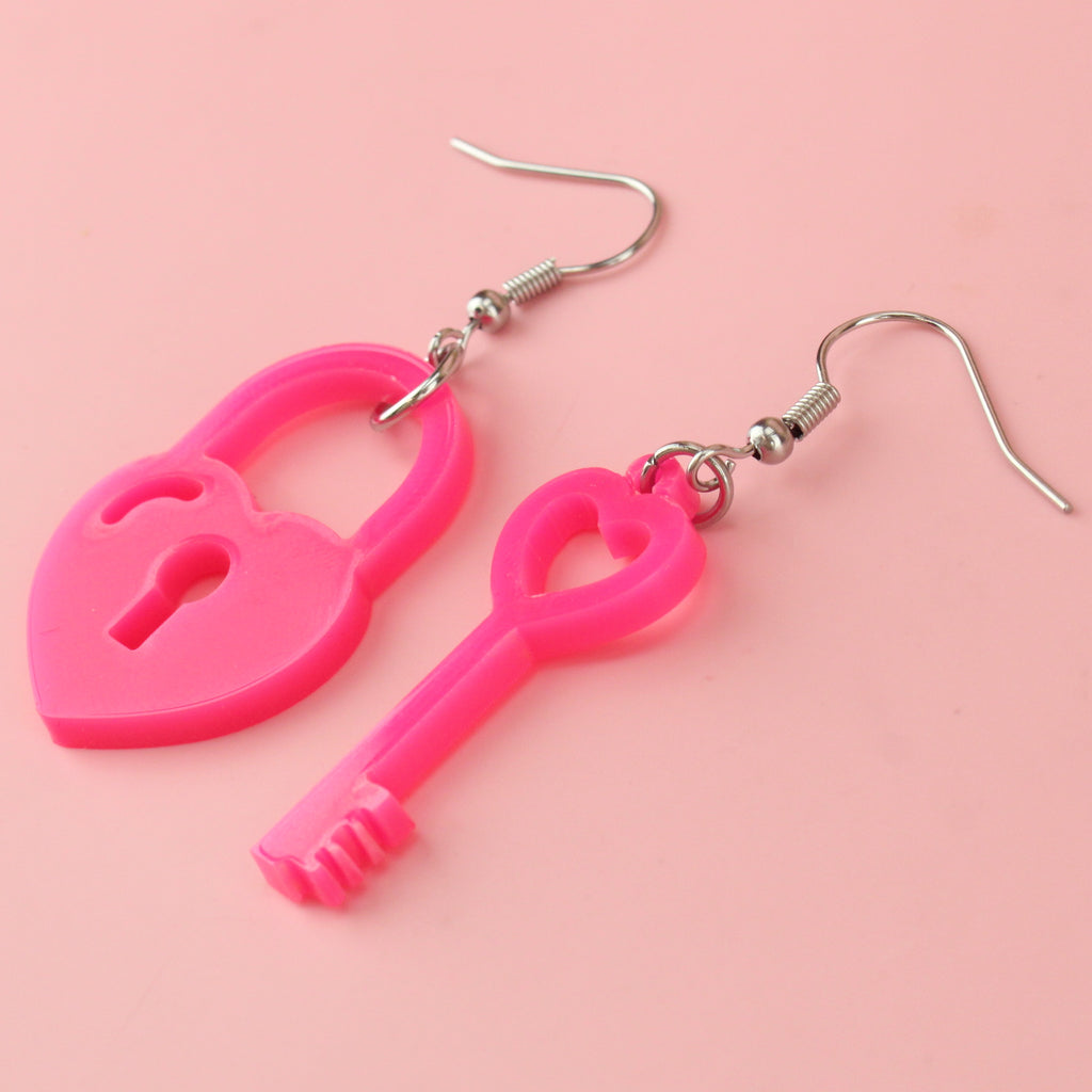 pink acrylic heart padlock charm and a heart-shaped key charm on stainl
