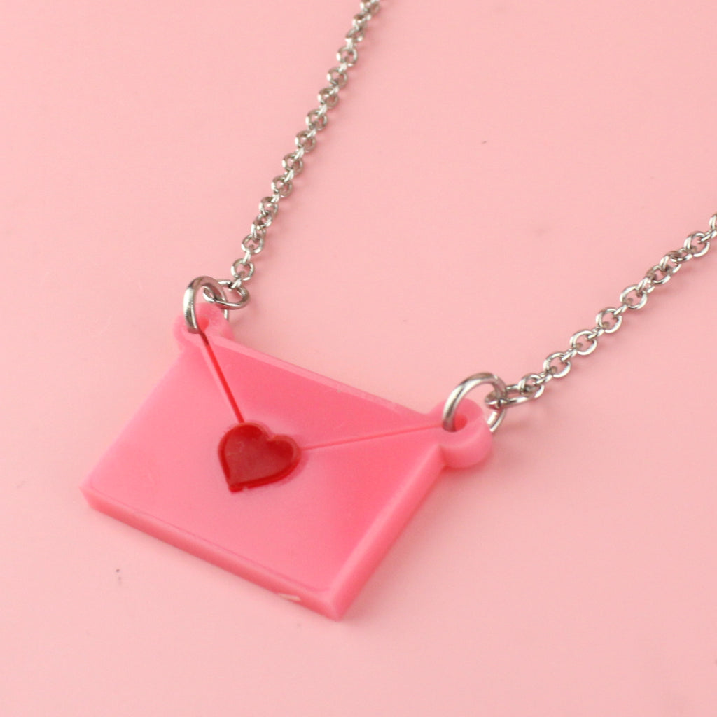 Close up of pink envelope pendant sealed with a red heart