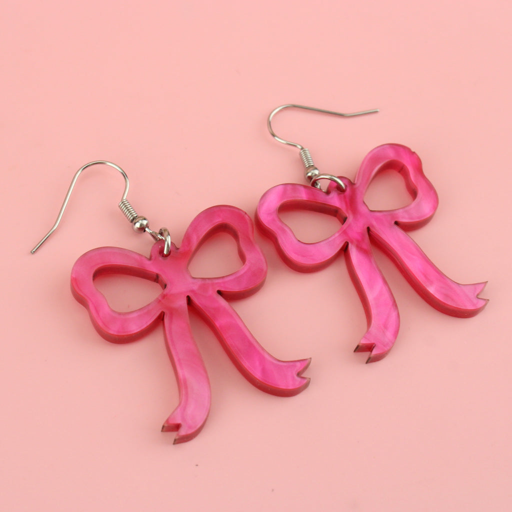 Pink marble bow shaped charms on stainless steel earwires