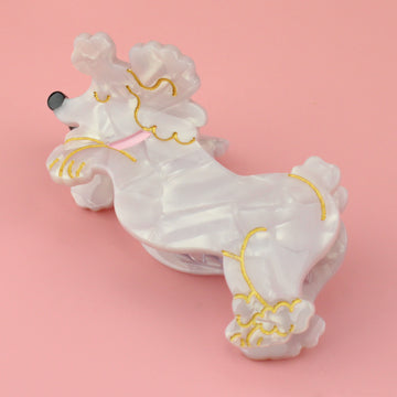 White marble poodle Claw clip with gold outlines and a pink collar