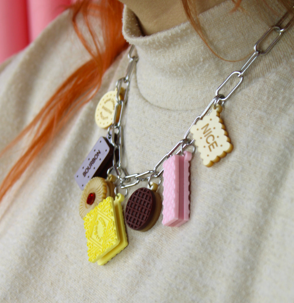 Bracelet with cookie-shaped charms on a neutral background