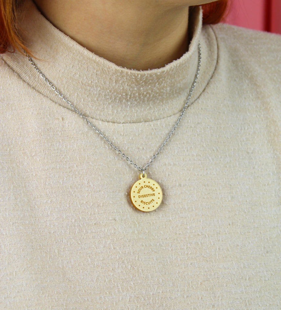 Necklace with a digestive biscuit pendant worn by model