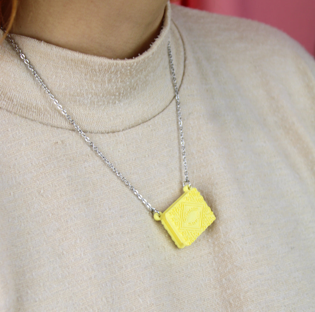 Custard cream necklace worn by model