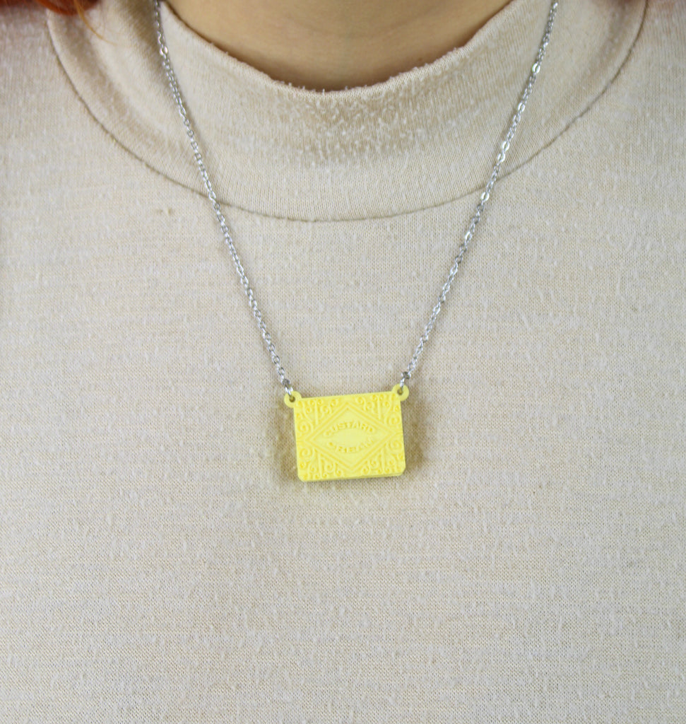 Custard cream necklace worn by model