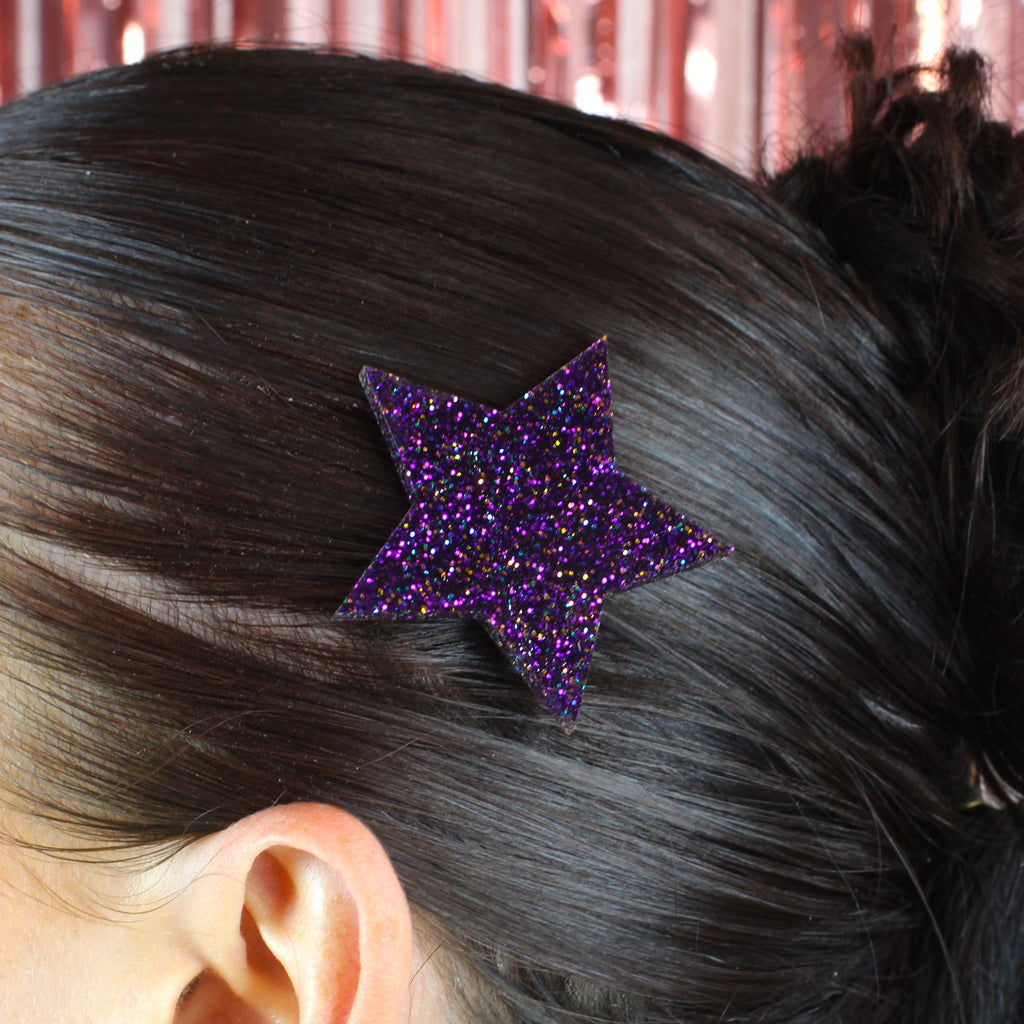 Model wearing purple glittery large star hair clip