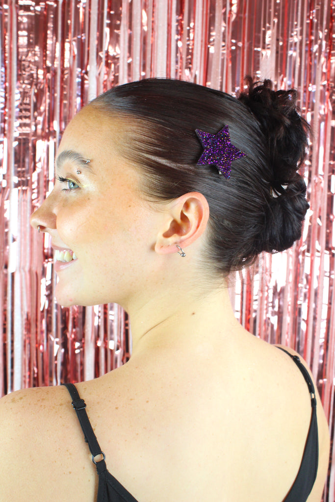 Model wearing purple glittery large star hair clip