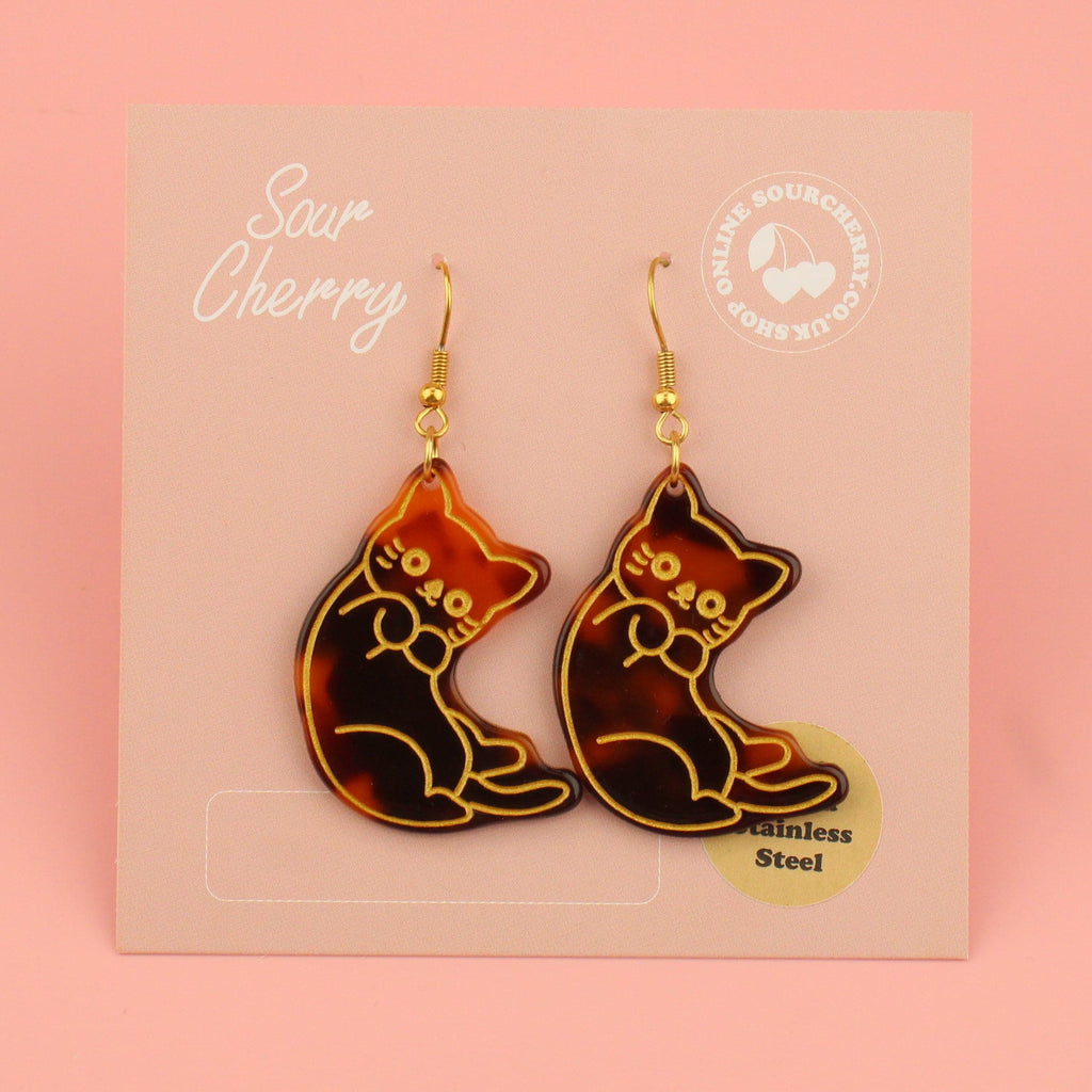 Resin tortoiseshell cat charms with a gold outline on gold plated stainless steel earwires shown on the card
