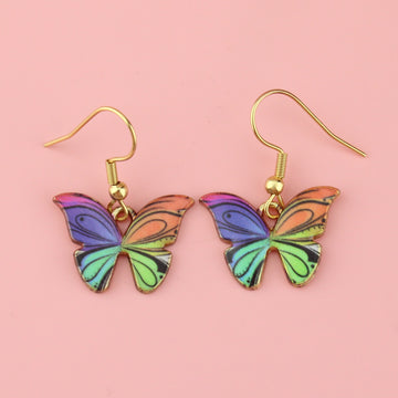 Gold plated rainbow butterfly-shaped charms on stainless steel earwires featuring hints of pink, purple,blue, red, orange and green