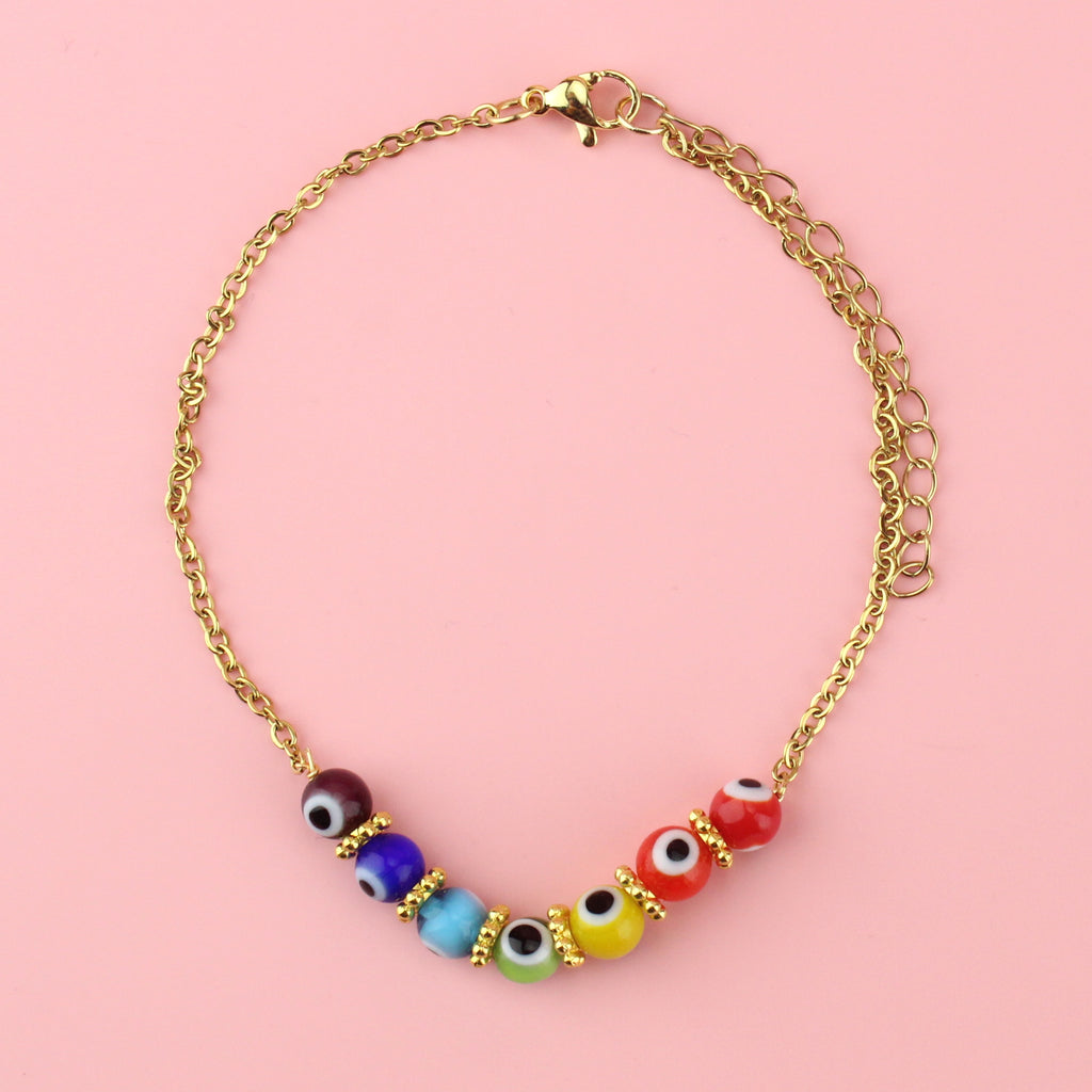 Purple, blue, turquoise green, yellow, orange and red glass beads with an evil eye on each bead on a gold plated stainless steel anklet