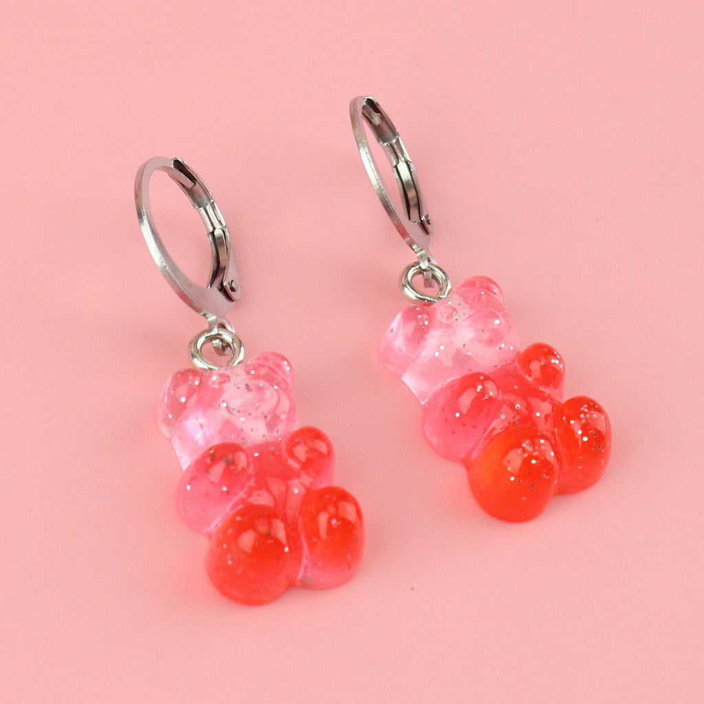 Pink and red glittery gummy bear charms on stainless steel huggie hoops