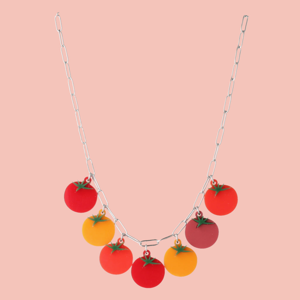 stainless steel oval link necklace featuring seven red and orange tomato pendants