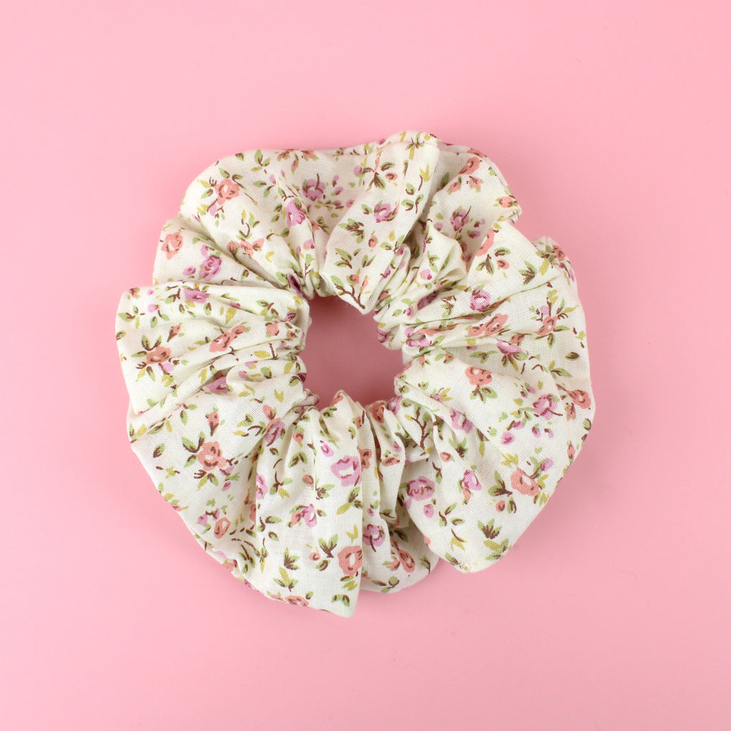 Cream scrunchie with a peach and pink rose print