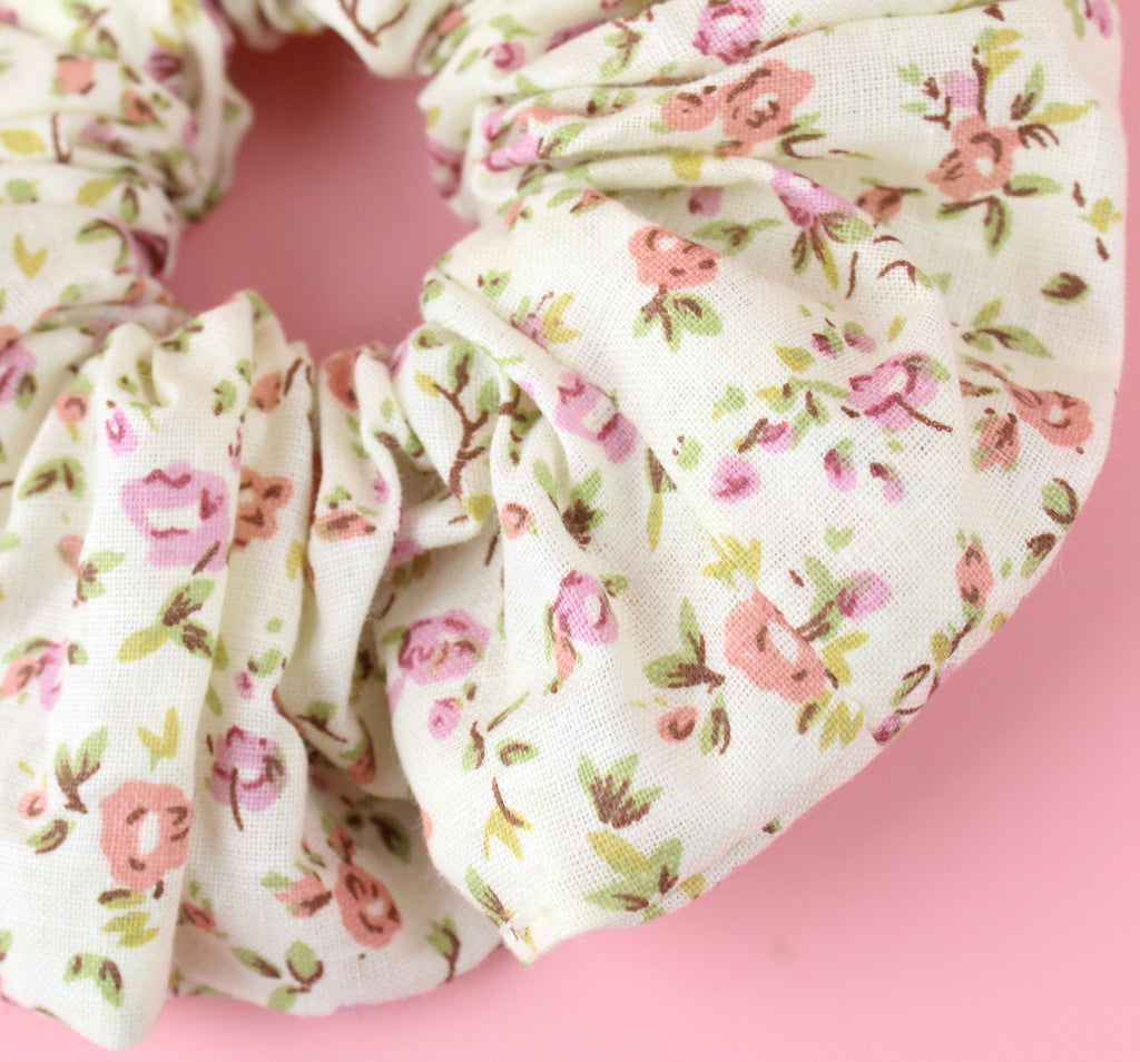Cream scrunchie with a peach and pink rose print