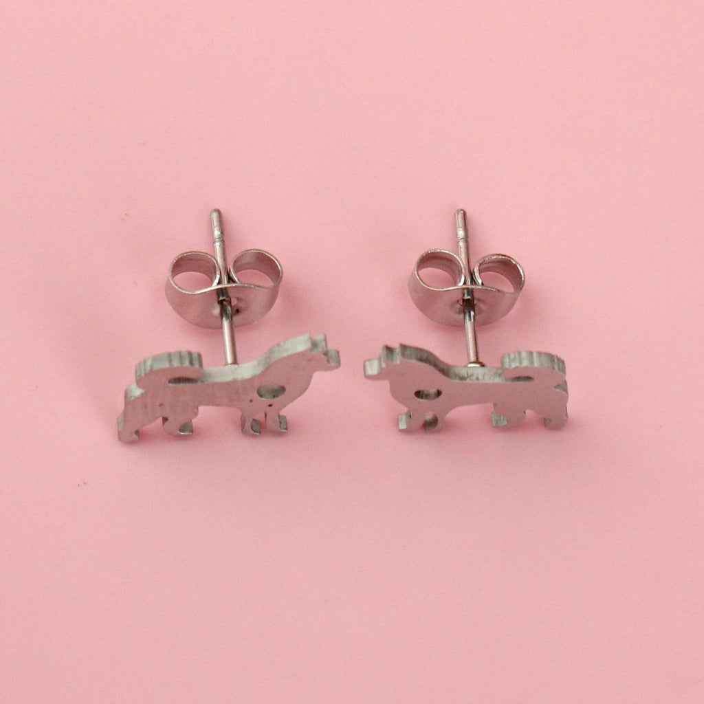 Stainless steel studs in the shape of a siberian husky with a cut out heart
