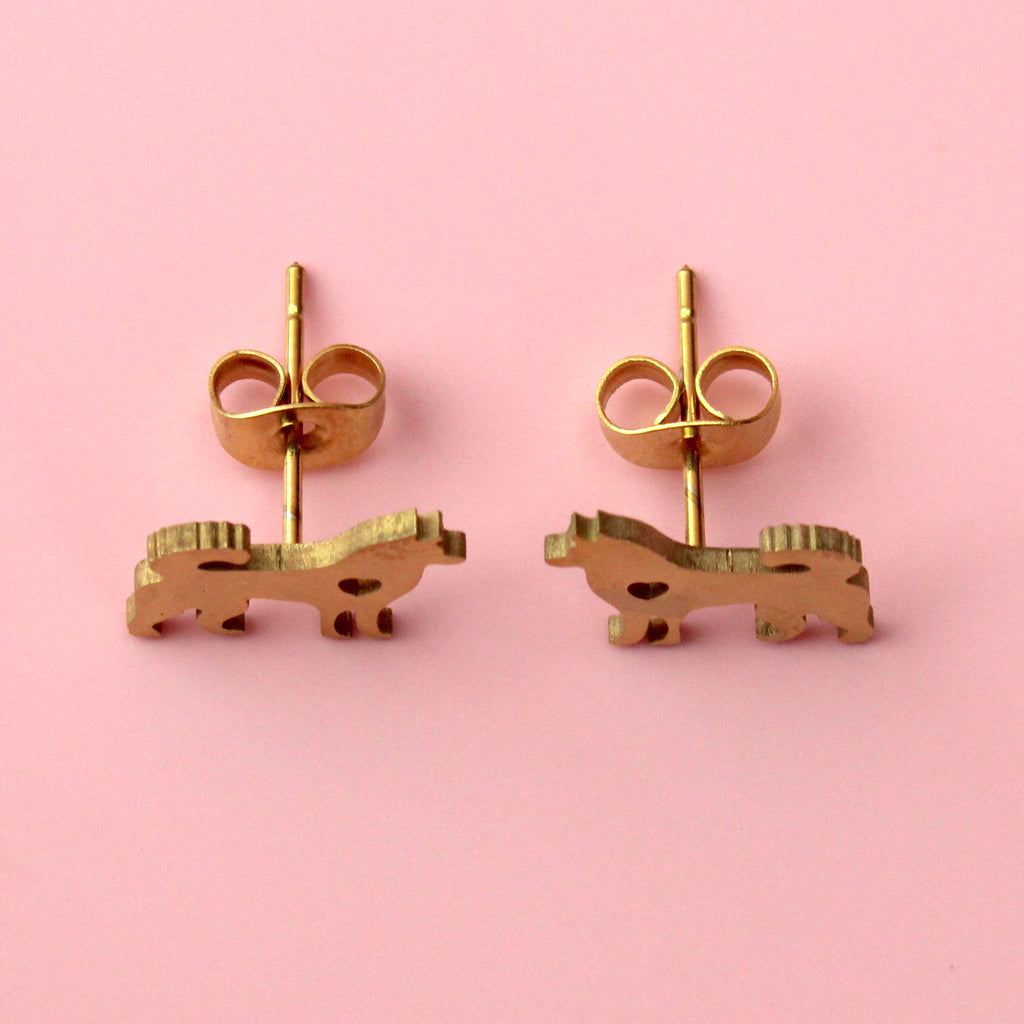 Gold plated stainlesss steel studs in the shape of a siberian husky with a cut out heart