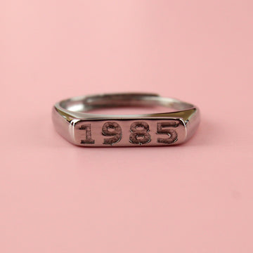 Stainless steel ring with 1985 engraved on the front