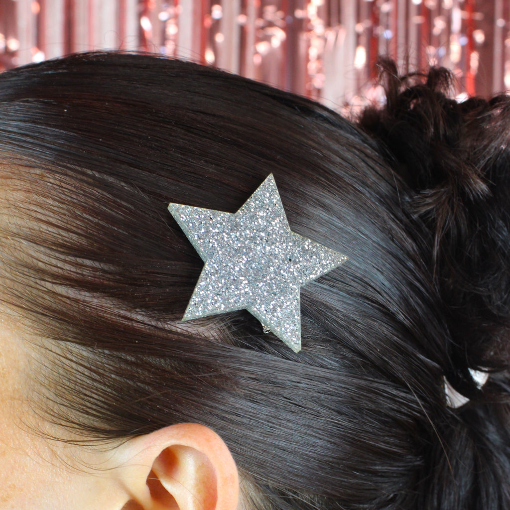 Model wearing large silver glittery star hair clip