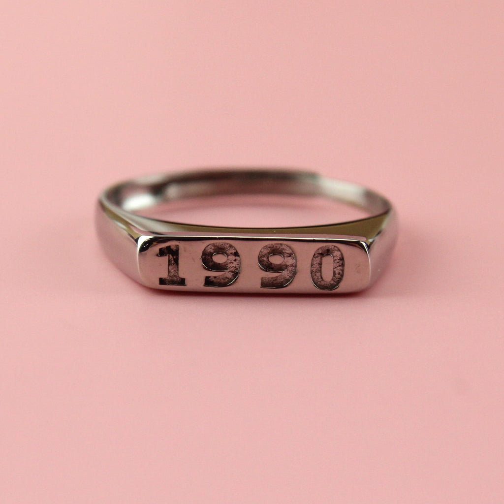 Stainless steel ring with 1990 engraved on the front