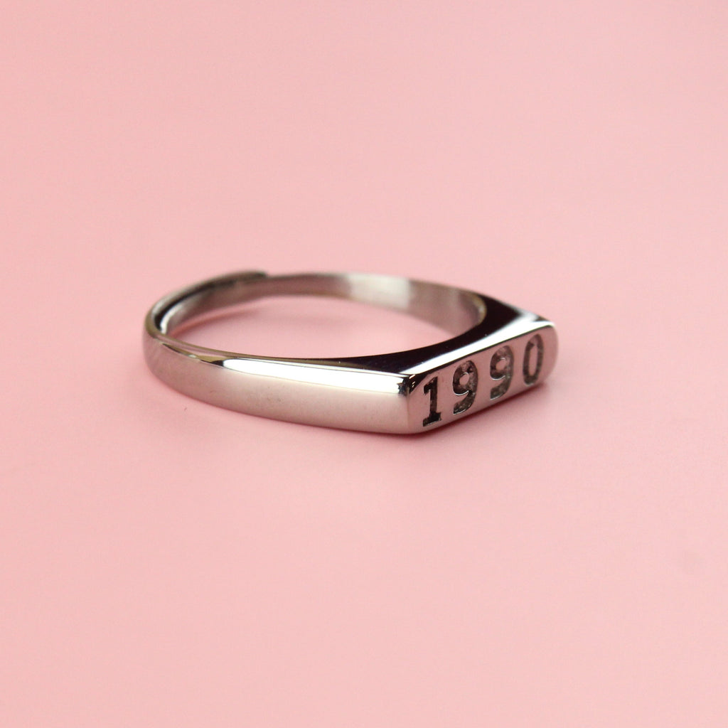 Stainless steel ring with 1990 engraved on the front