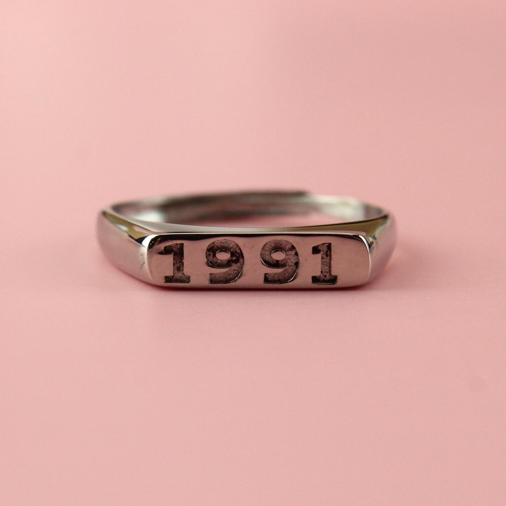 Stainless steel ring with 1991 engraved on the front