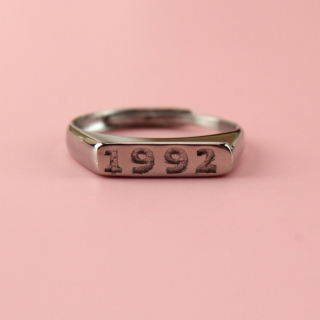 Stainless steel ring with 1992 engraved on the front