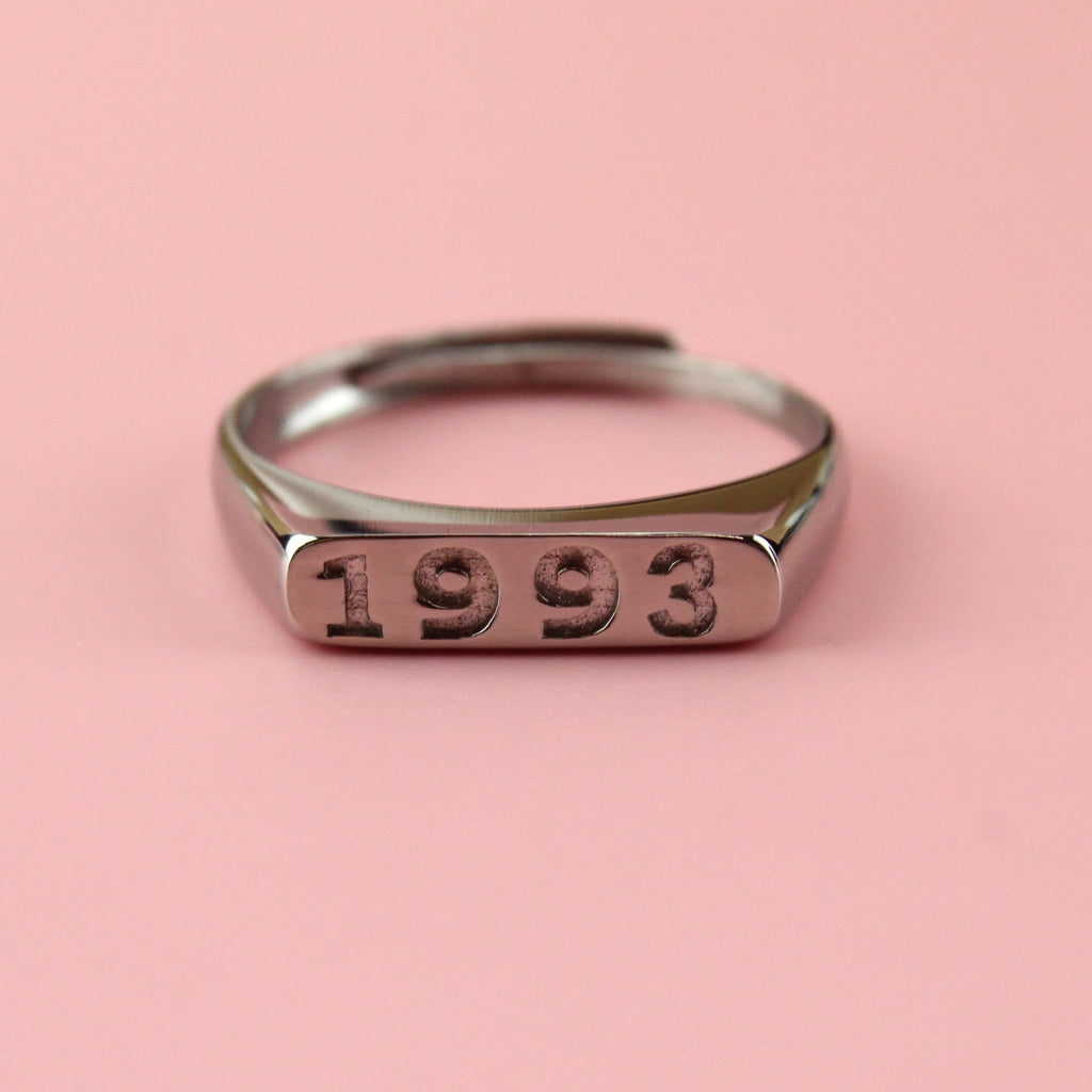 Stainless steel ring with 1993 engraved on the front