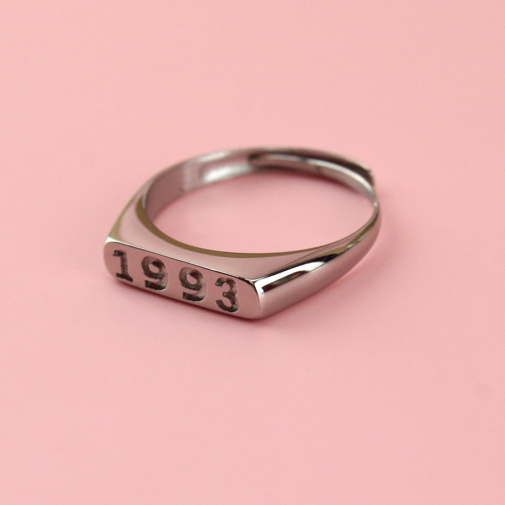 Stainless steel ring with 1997 engraved on the front
