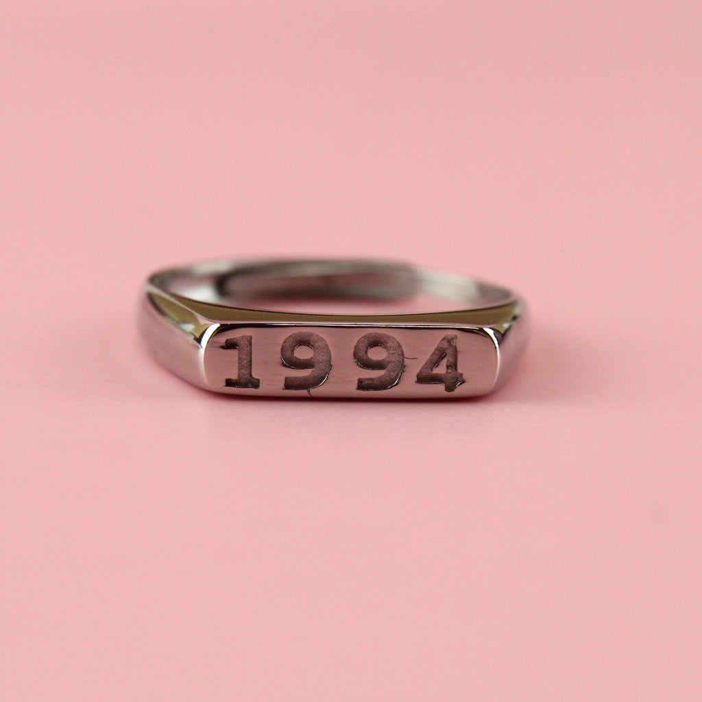 Stainless steel ring with 1994 engraved on the front