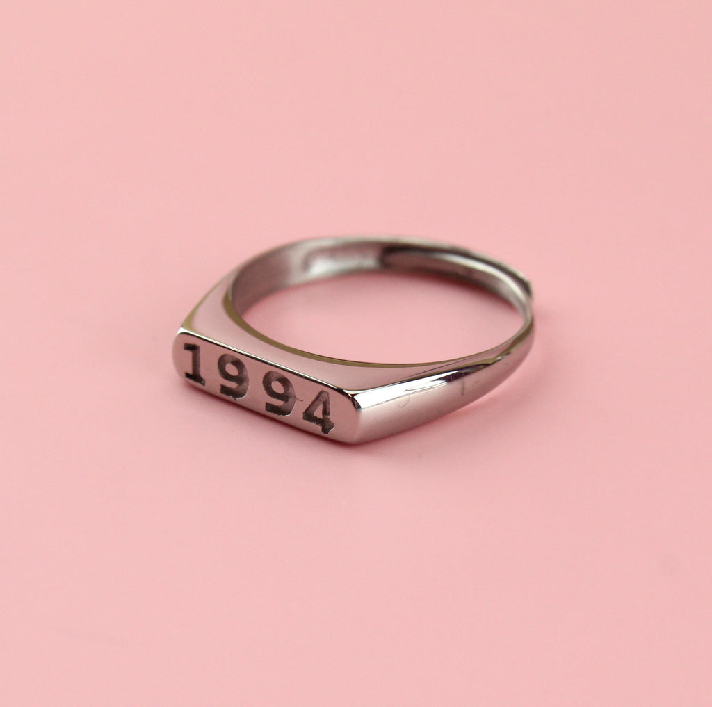 Stainless steel ring with 1994 engraved on the front