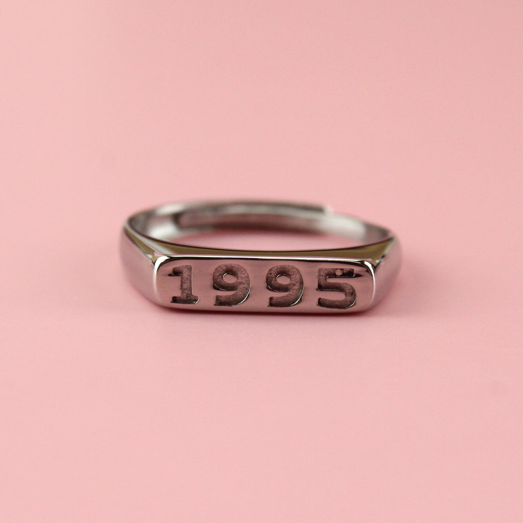 Stainless steel ring with 1995 engraved on the front