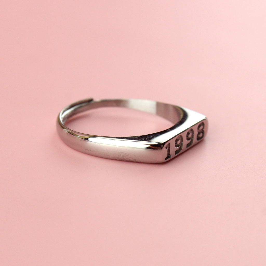 Stainless steel ring with 1998 engraved on the front