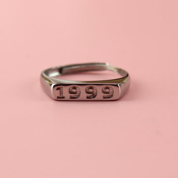 Stainless steel ring with 1999 engraved on the front