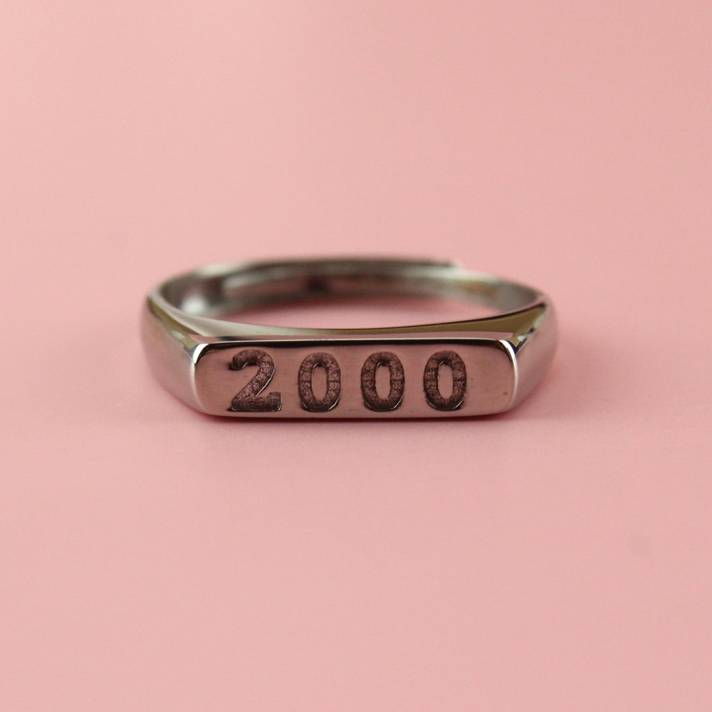 Stainless steel ring with 2000 engraved on the front