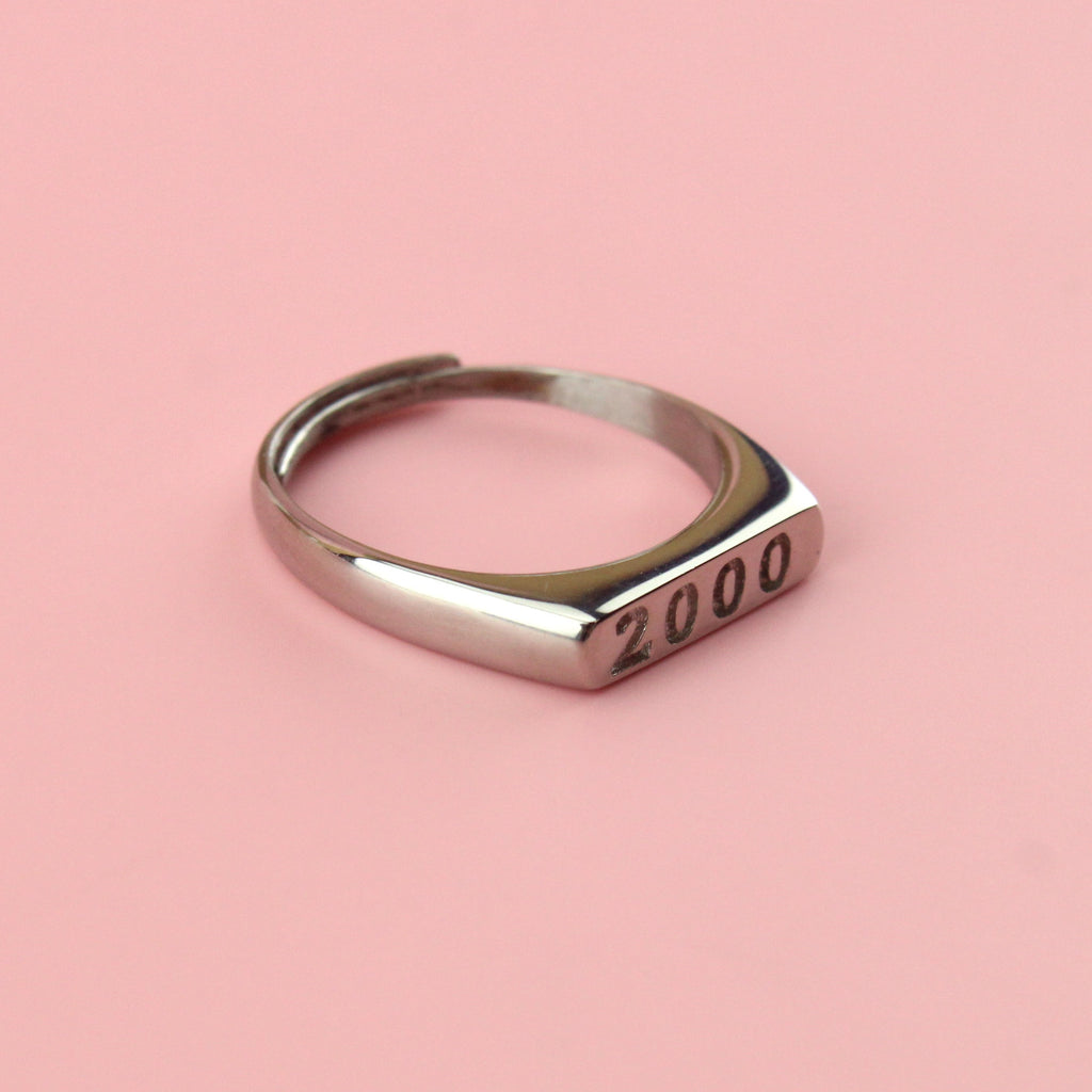 Stainless steel ring with 2000 engraved on the front