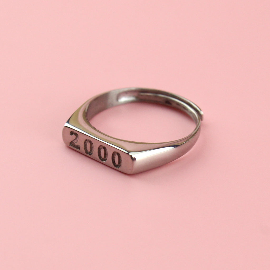 Stainless steel ring with 2000 engraved on the front