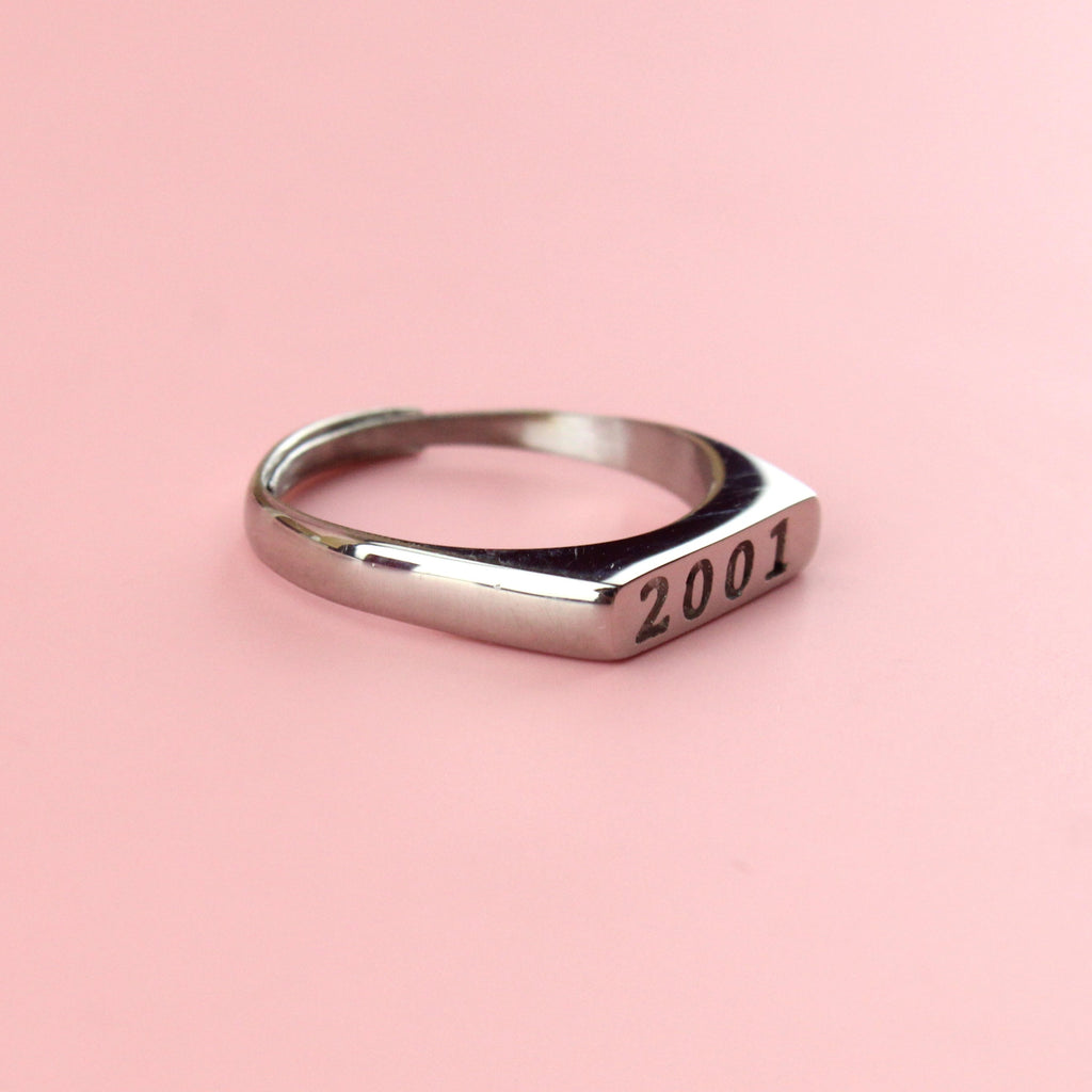 Stainless steel ring with 2001 engraved on the front