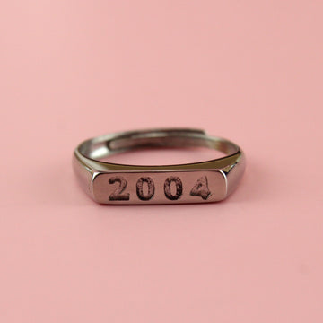 Stainless steel ring with 2004 engraved on the front