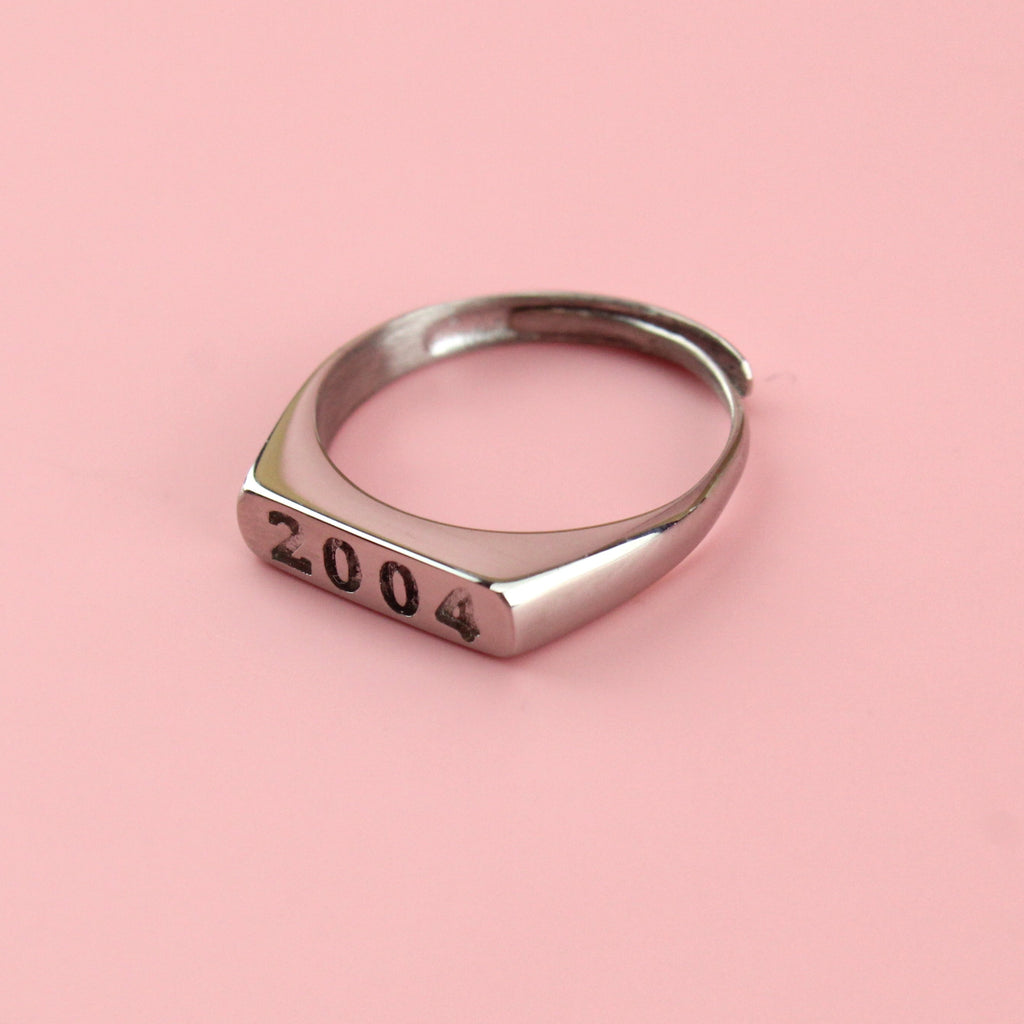 Stainless steel ring with 2004 engraved on the front