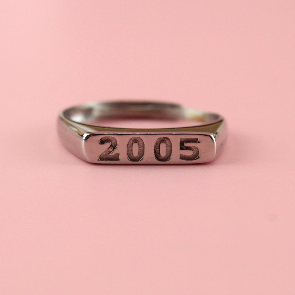Stainless steel ring with 2005 engraved on the front