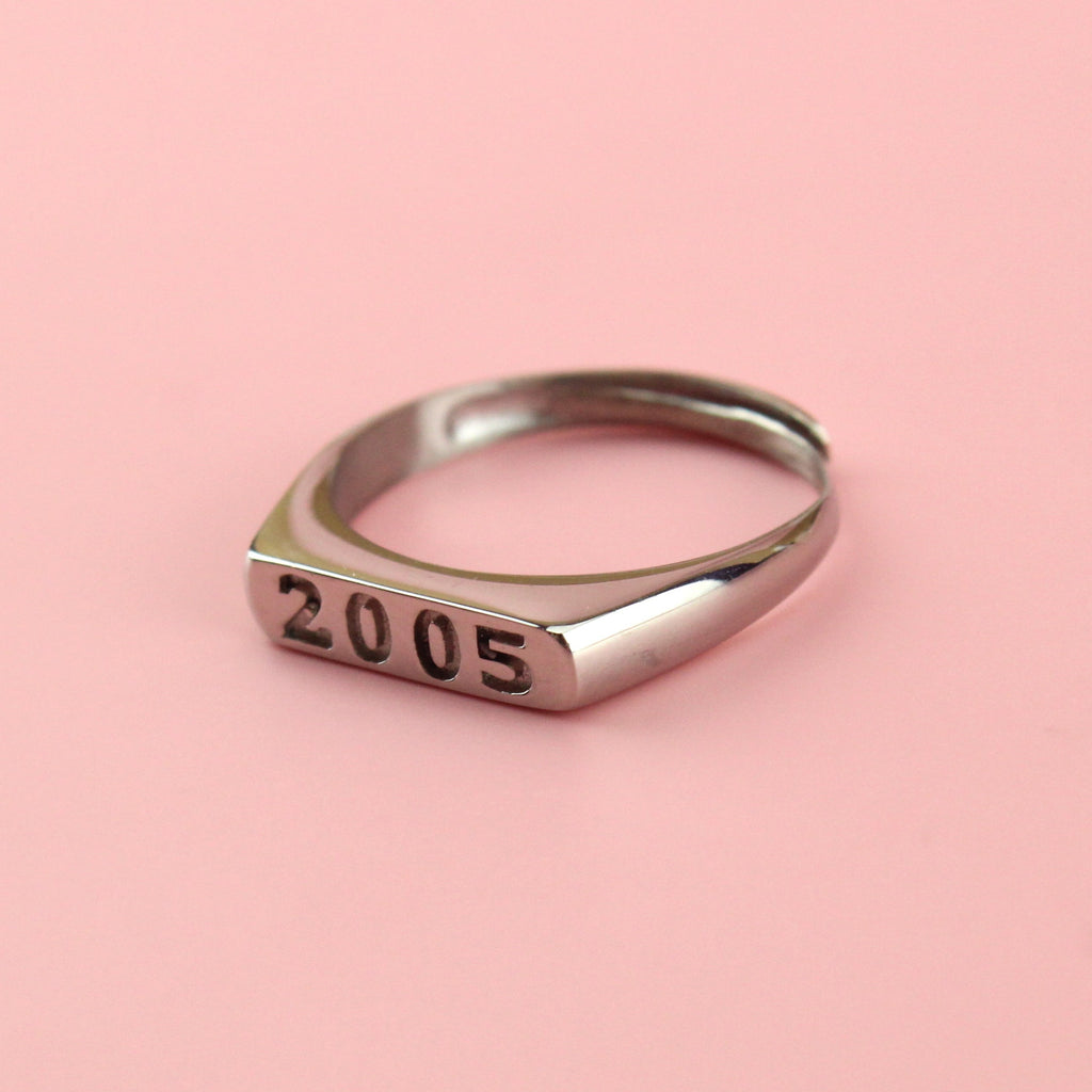 Stainless steel ring with 2005 engraved on the front