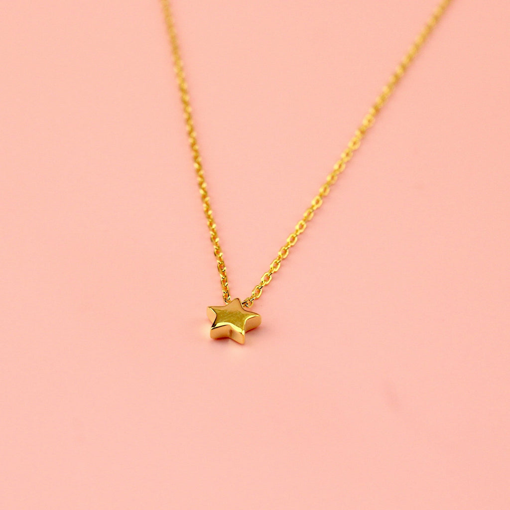 Gold plated sterling silver chain with a small sterling silver gold plated star charm.