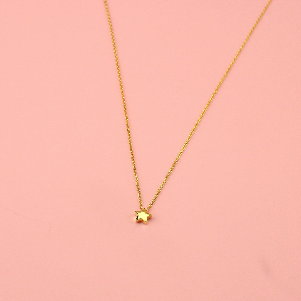 Gold plated sterling silver chain with a small sterling silver gold plated star charm.