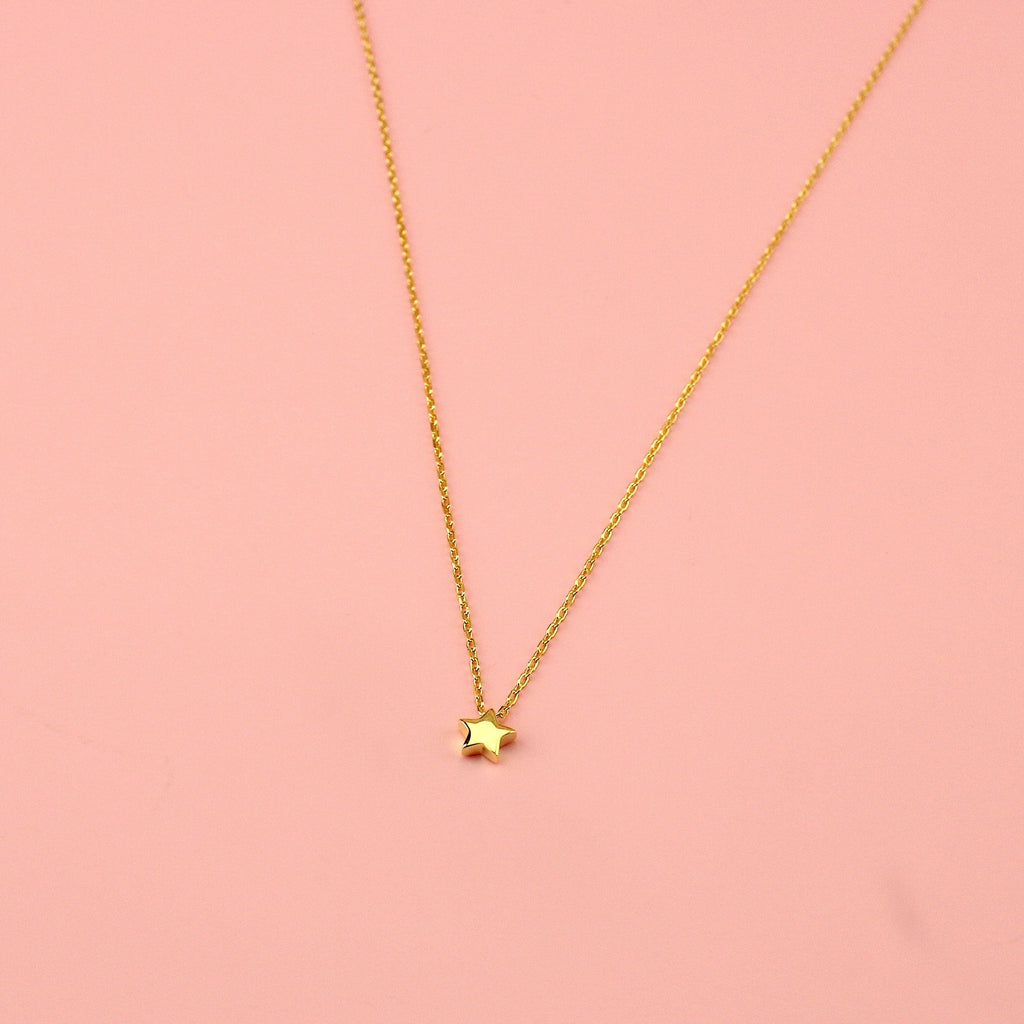 Gold plated sterling silver chain with a small sterling silver gold plated star charm.