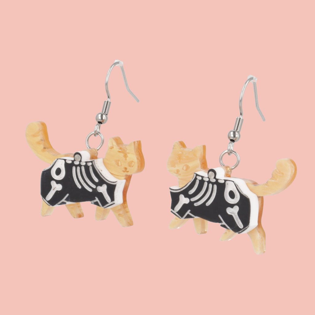 model wearing ginger cat skeleton charms on stainless steel earwires 