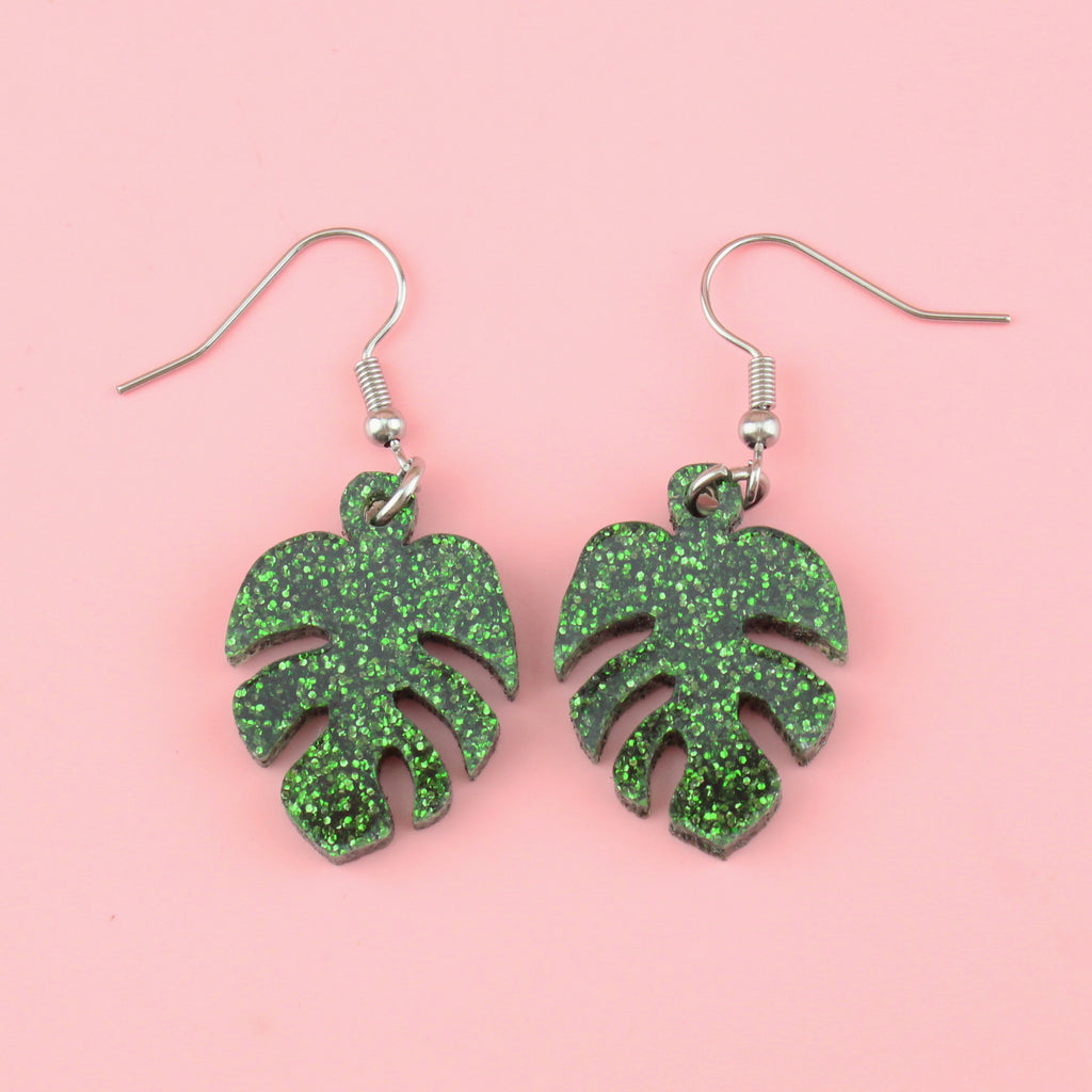 Green glittery monstera charms on stainless steel earwires