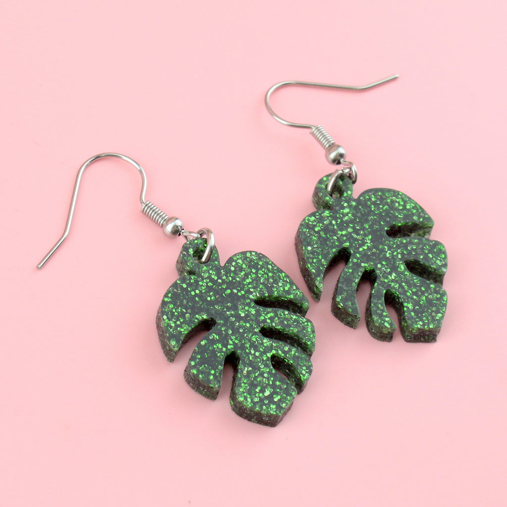 Green glittery monstera charms on stainless steel earwires