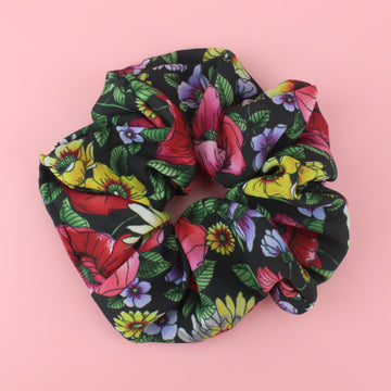 Dark Green Scrucnhie with a floral pattern featuring red, pink, yellow and lilac flowers and green leaves