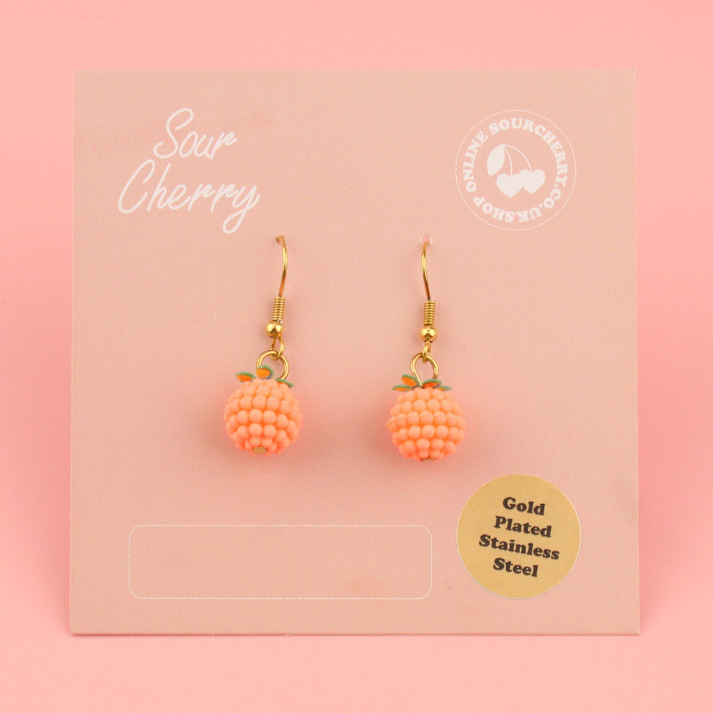 Bobbly oranges on gold plated stainless steel earwires shown on the card